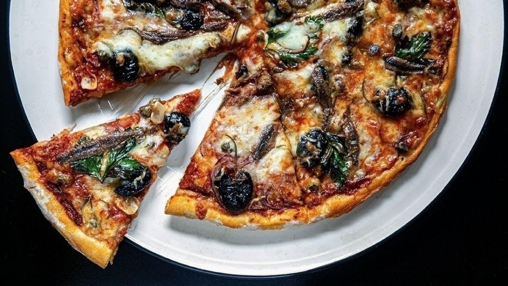 Olive and anchovy pizza with a crispy crust