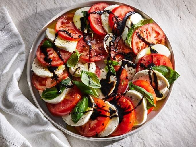 Olive and caprese salad with balsamic glaze